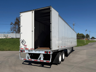 Trailer with open rear doors of a 2022 Wabash DuraPlate dry van trailer showing rear bumper, taillights, and triple axle configuration.