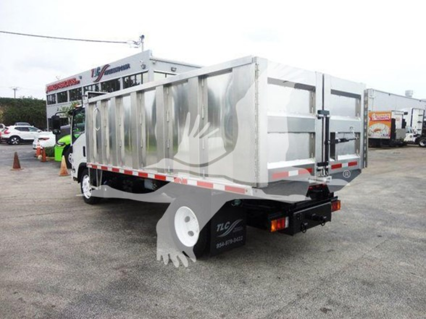 Isuzu NQR dump truck rear/side view showing aluminum dump bed and taillights