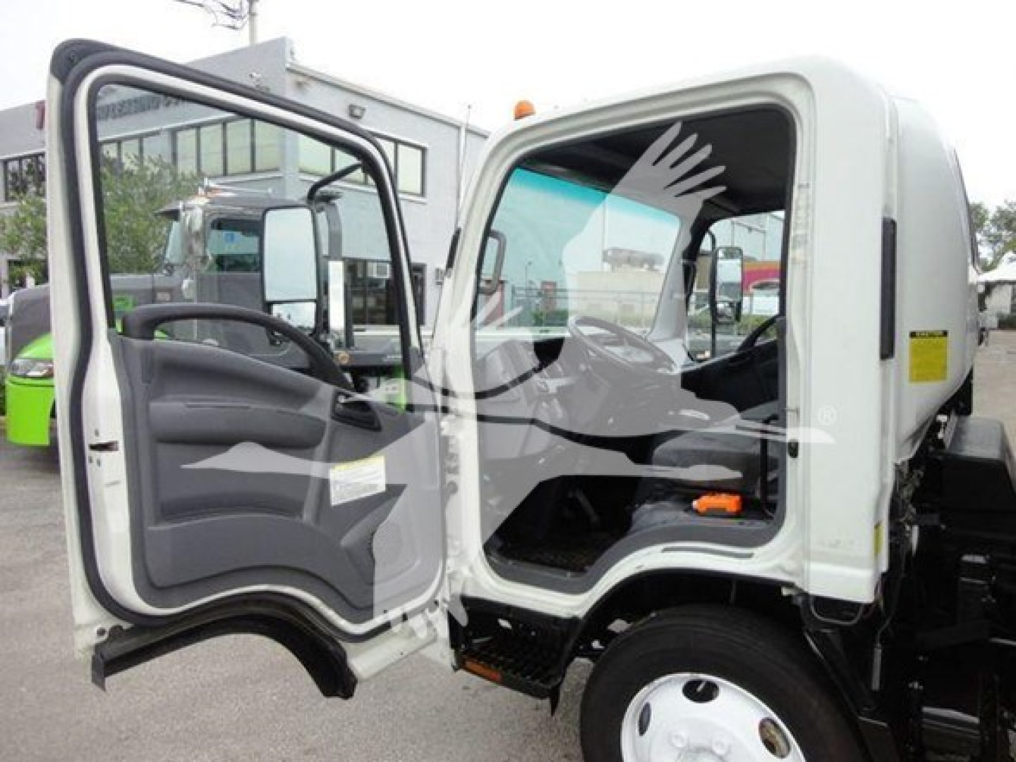 Isuzu NQR truck cab with open driver door showing interior dash and seating.