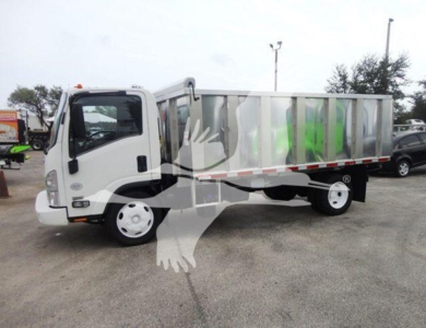 Isuzu NQR dump truck in a truck lot showing a white cab and silver dump bed with green accents on side panels.