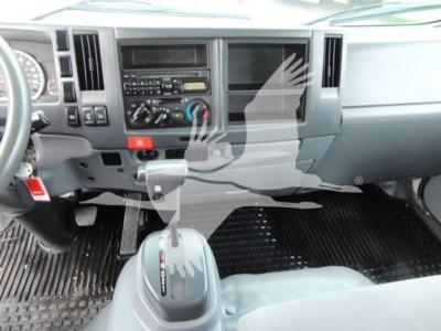 Isuzu NQR interior dashboard and gear shifter showing central console and steering wheel area.