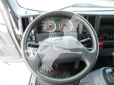 Isuzu NQR interior showing steering wheel and instrument cluster with gauges and dashboard controls