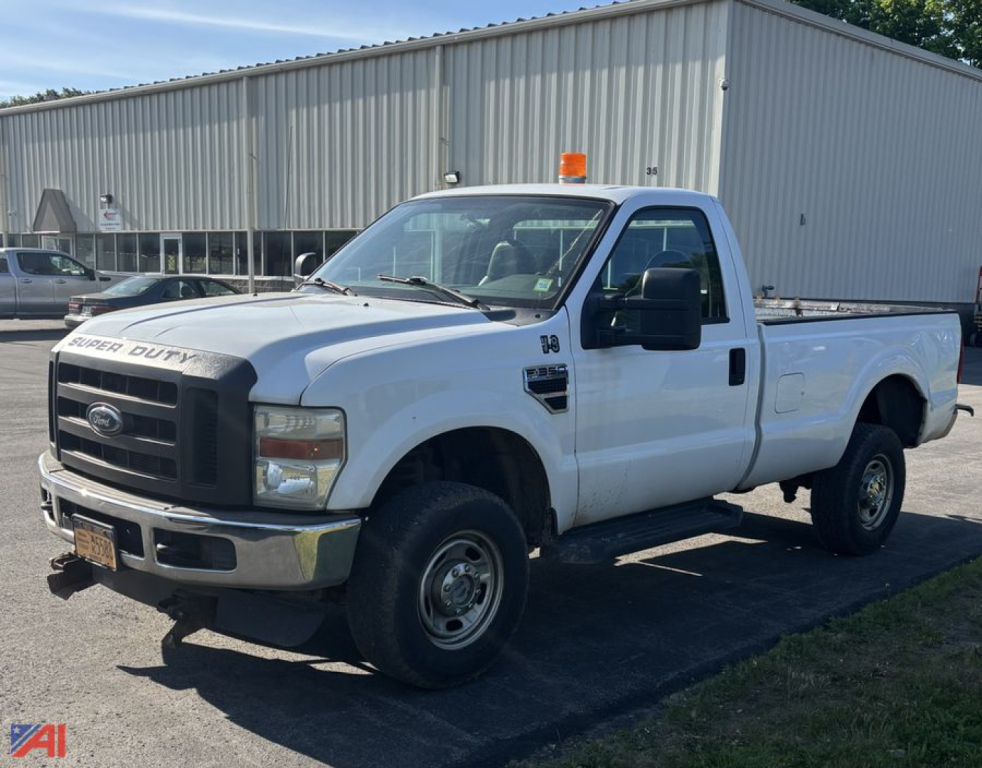 Ford F-350 pickup truck in white showing single cab, long bed, orange beacon on roof, front grille, and side mirrors.