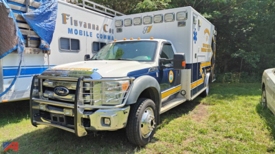 Ford F-450 ambulance with front bull bar and blue and white livery, large rear patient compartment, ambulance graphics on side.