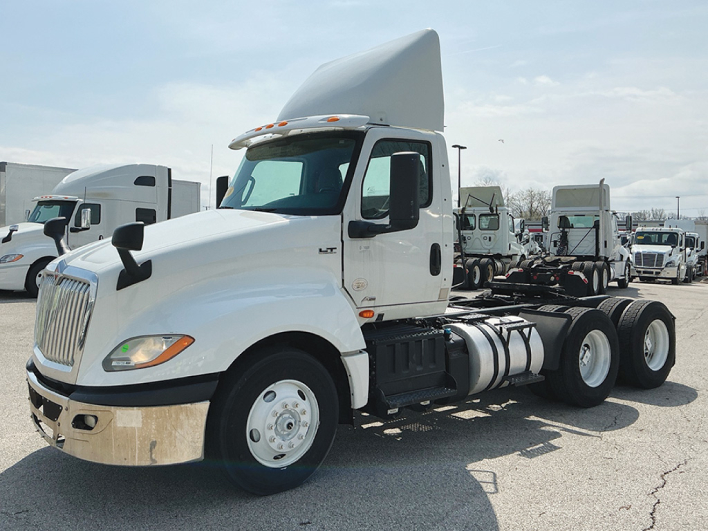 International LT625 daycab truck in side view showing cab, front bumper, fuel tanks, and rear tandem axles with fifth wheel mounting.