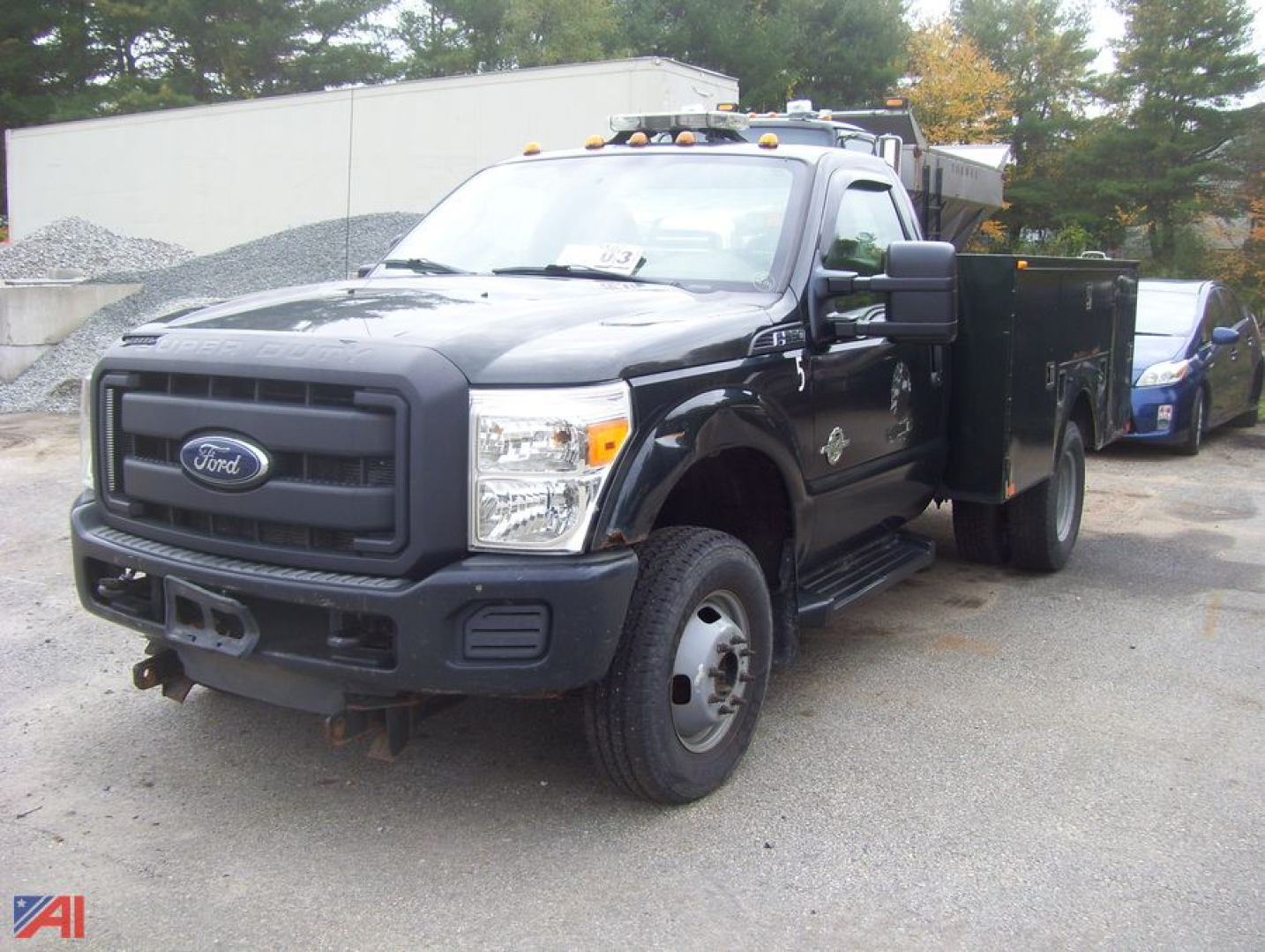 Ford F-350 Super Duty dual rear wheel service truck with utility bed, black exterior, front bumper with tow hooks, Ford emblem on grille.
