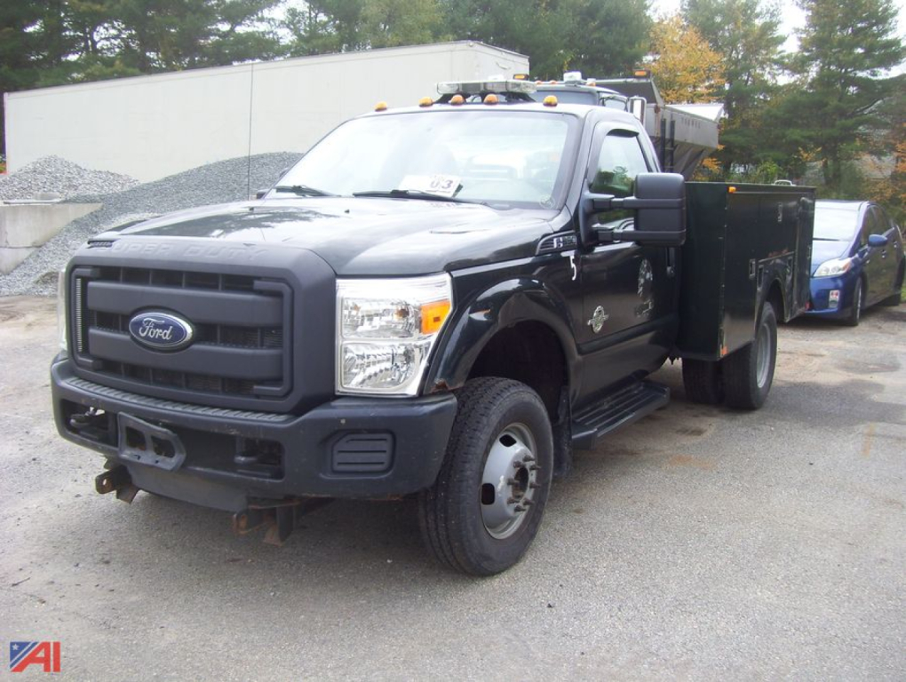 Ford F-350 Super Duty dual rear wheel service truck with utility bed, black exterior, front bumper with tow hooks, Ford emblem on grille.
