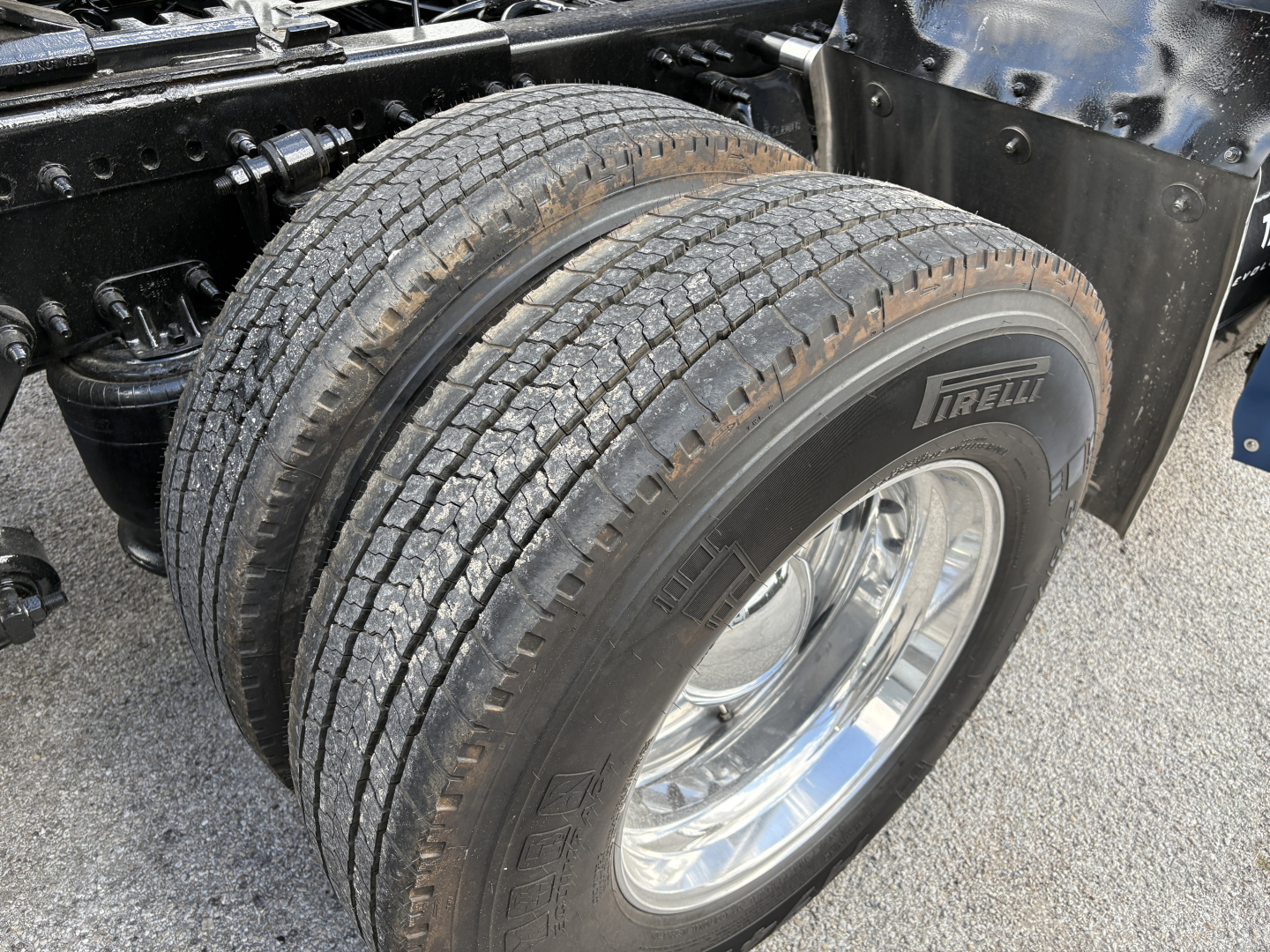 Wheel pair on Freightliner Cascadia 126 chassis showing dual rear tires and chrome wheel rims with Pirelli tire branding.
