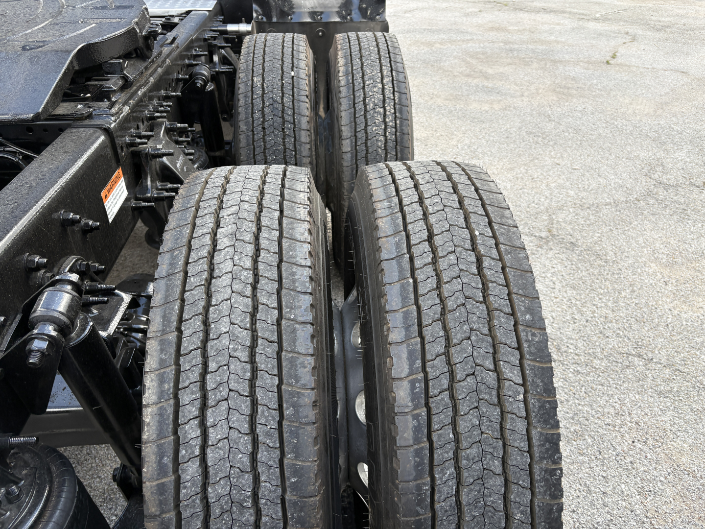 Truck chassis and dual rear wheels with tires visible in a Freightliner Cascadia 126 side-profile view.