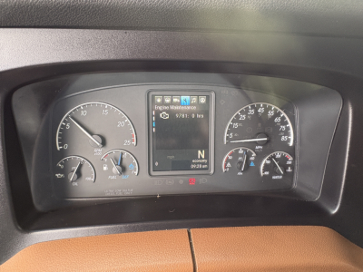 Dashboard of a Freightliner Cascadia 126 showing instrument cluster and center display with 'Engine Maintenance' message.