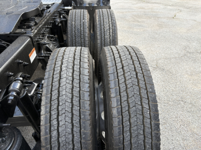 Truck chassis and dual rear wheels with tires visible in a Freightliner Cascadia 126 side-profile view.