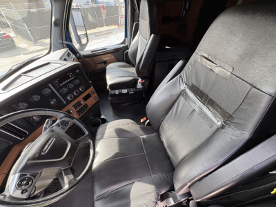 Freightliner Cascadia 126 truck interior driver and passenger seats with dashboard controls visible.