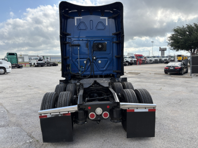Freightliner Cascadia 126 truck rear view showing fifth wheel and dual rear axles with mud flaps and bumper lights.