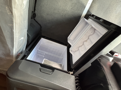 Freightliner Cascadia 126 sleeper cab interior showing under-seat storage with open small cooler box