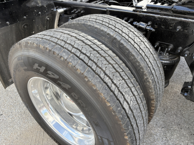 Truck wheel and dual tires of a Freightliner Cascadia 126 front suspension showing Michelin tires and wheel rim.
