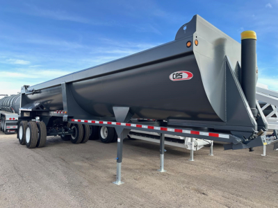 CPS Frameless Rock End Dump trailer showing side view with gray and black steel construction, dual rear axles, and support legs extended.