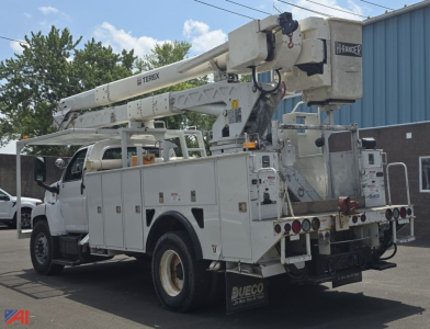 GMC TopKick C7500 utility truck with bucket lift in service configuration showing boom arm and bucket platform