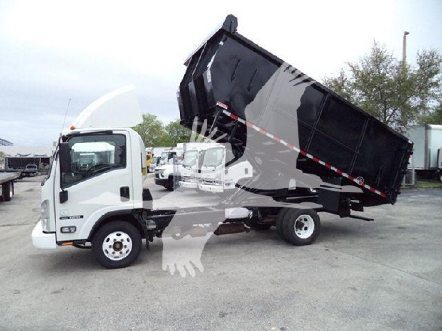 Isuzu NPR dump truck with raised black dump body in service position, white cab, side view showing hydraulic lift and cargo bed outline.
