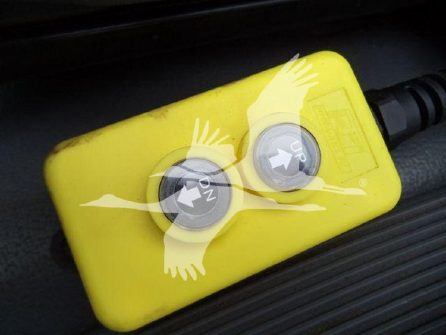Isuzu NPR engine bay showing yellow two-button remote switch with ON/OFF labels.