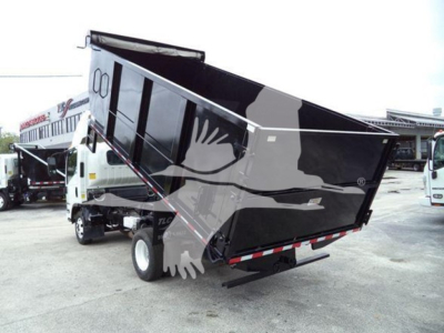 Isuzu NPR dump truck in-service showing a raised black dump bed with white truck cab and side mirrors.