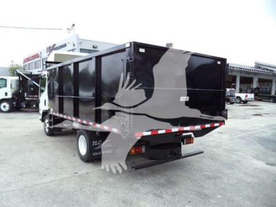 Isuzu NPR dump truck with a black dump body, rear view showing tail lights and reflective tape.