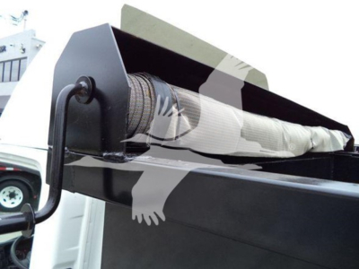 Isuzu NPR dump truck bed showing folded tarp mechanism and hydraulic roller.