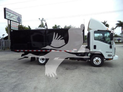 Isuzu NPR dump truck side view showing cargo bed and cab with white cabin and black dump body.