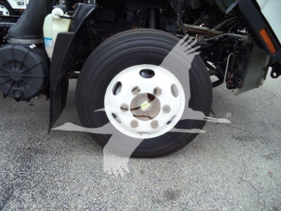 Isuzu NPR front wheel and suspension view with wheel hub, tire, and surrounding truck components visible