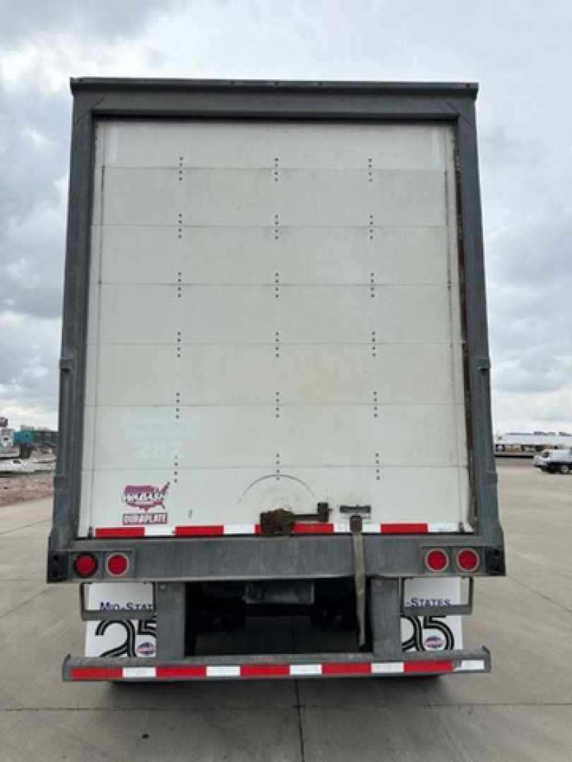 Trailer rear view of a 2016 Wabash van showing rear doors and bumper with taillights and plate area.