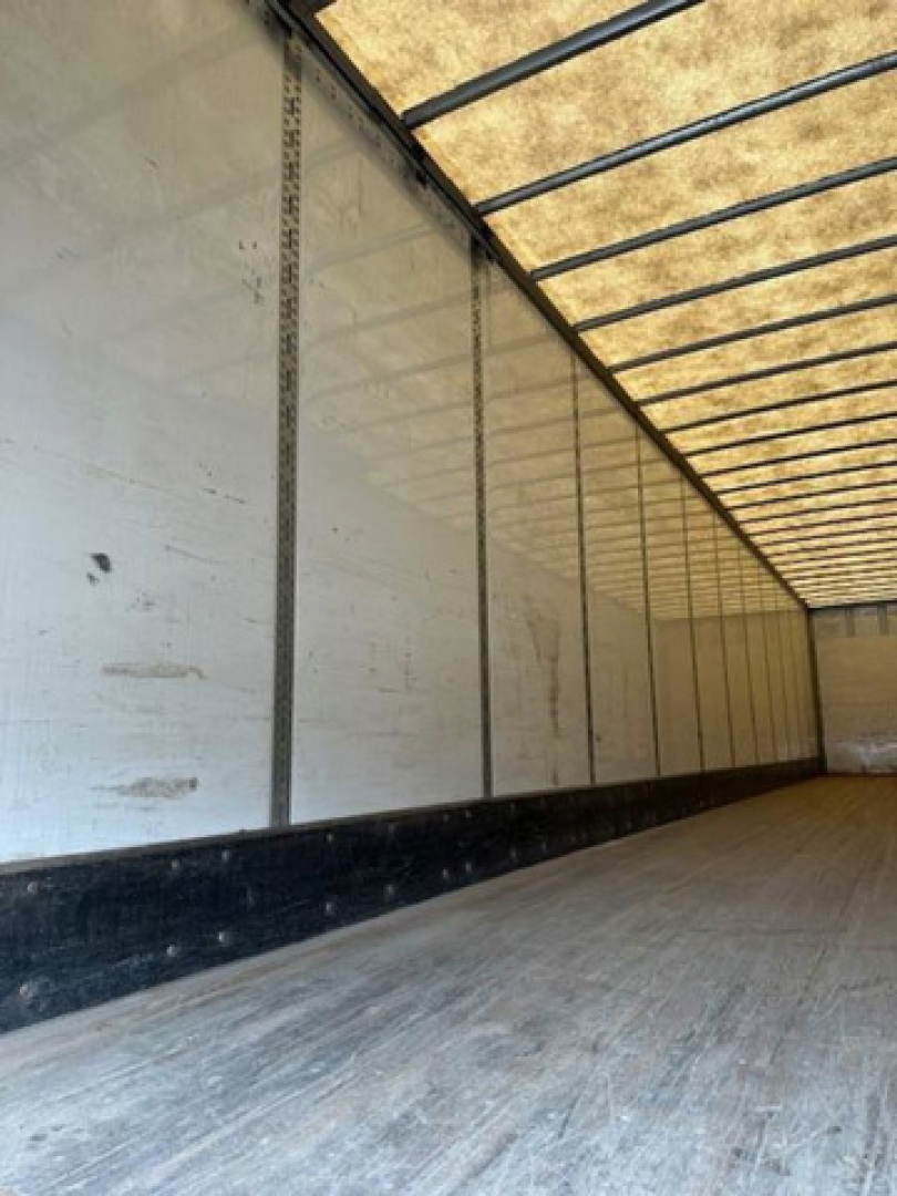 Trailer interior showing metal side walls and wooden floor of a used 2016 Wabash van trailer.