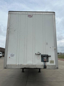 Rear view of a white 2016 Wabash van trailer showing door latch and hitch mechanism, stock U90827, VIN 1JJV532D9GL908620.