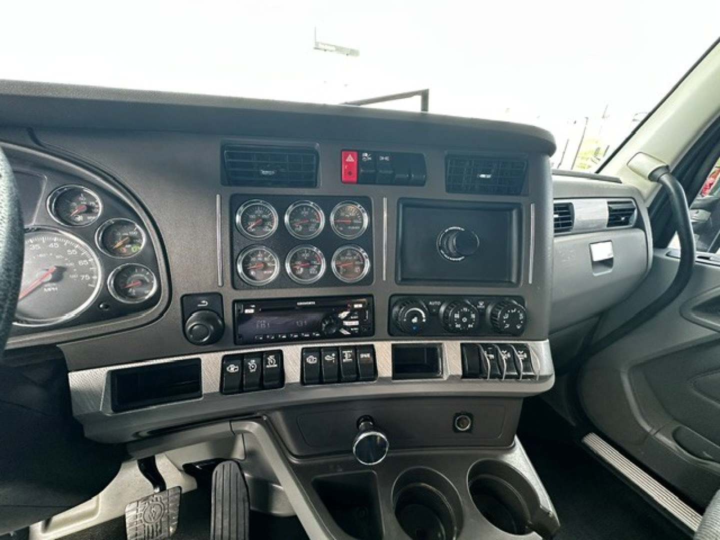 Kenworth T880 dash and instrument cluster showing gauges and controls in cab view.