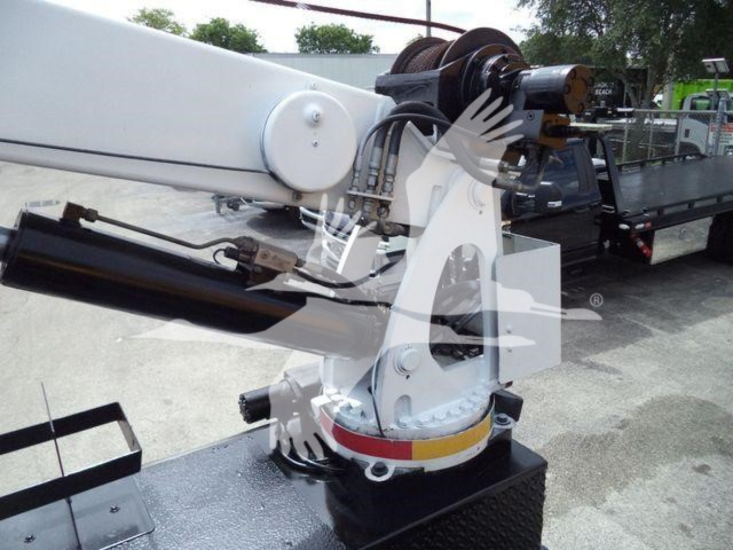 Boom crane arm and hydraulic mechanism on a Kenworth T270 service truck showing crane base and winch assembly.