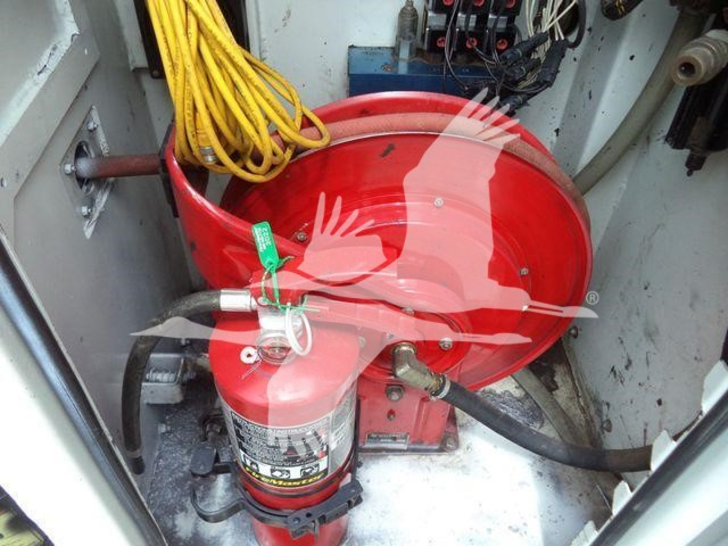 Kenworth T270 engine bay view with red circular component, yellow cables, and a mounted fire extinguisher.