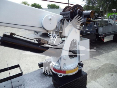 Boom crane arm and hydraulic mechanism on a Kenworth T270 service truck showing crane base and winch assembly.