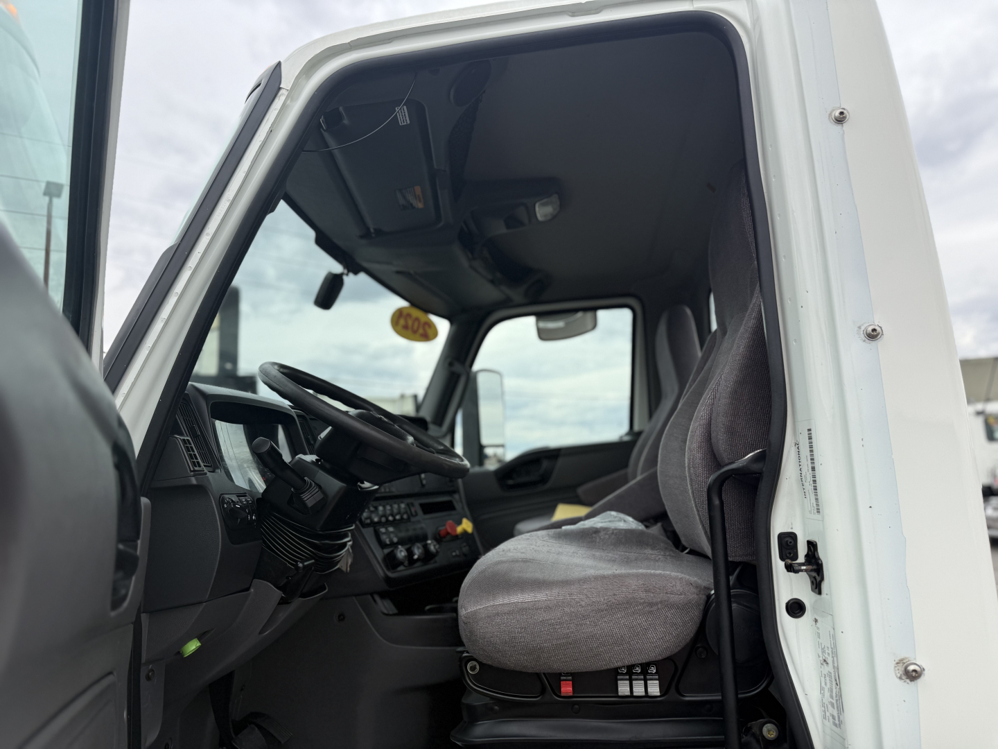 Interior of a 2021 International LT625 truck cab showing steering wheel and driver's seat.