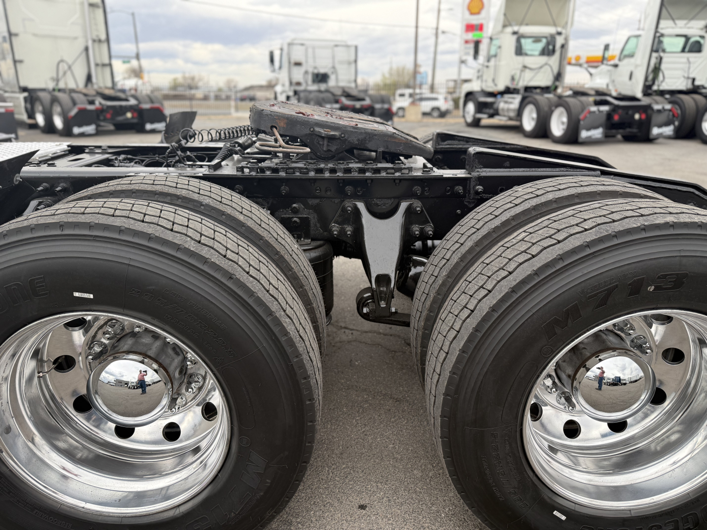 Dual rear axles view showing suspension and tires with polished chrome wheels on a 2021 International LT625 truck chassis.