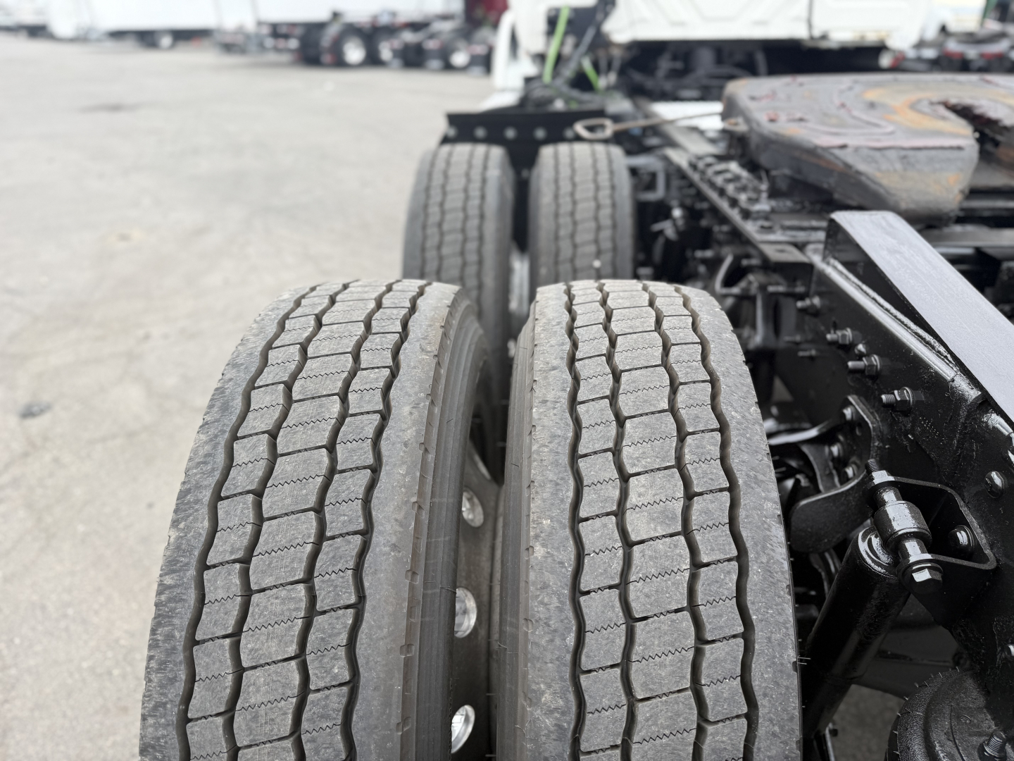 Truck rear dual tires with suspension and frame visible; part of International LT625 truck chassis.
