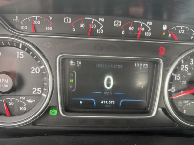 Dashboard view of a 2021 International LT625 cab: central digital speedometer shows 0 mph, gear indicators, odometer 419,375 miles, fuel gauges and multiple analog gauges around.