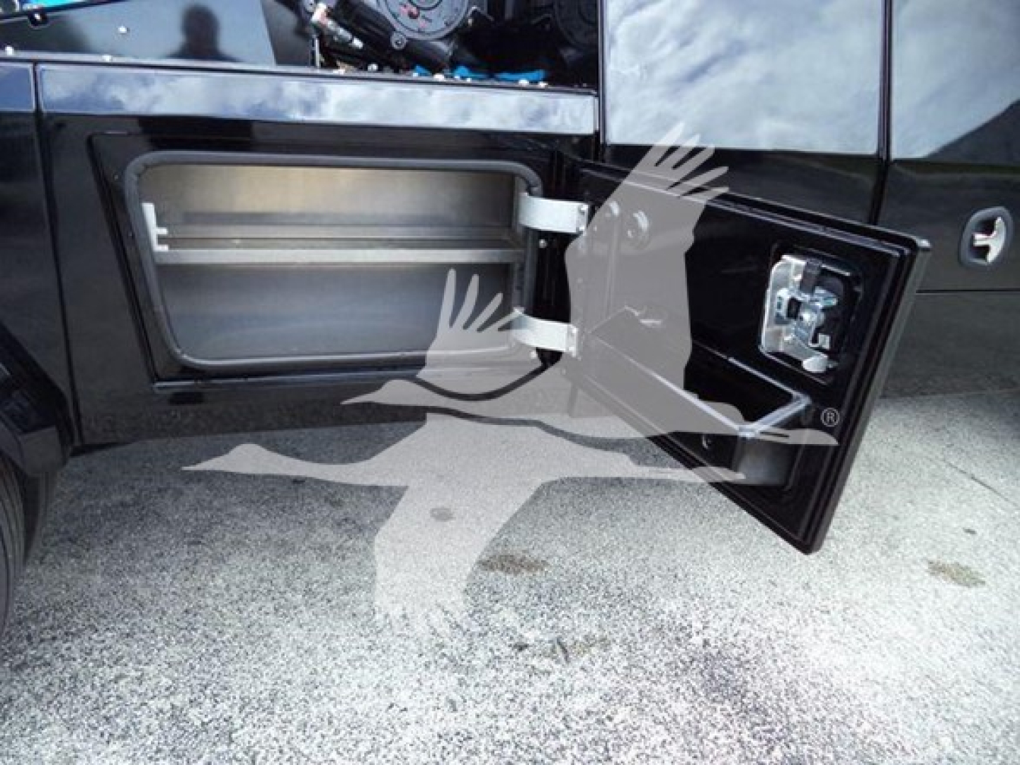 Truck side fuel fill door open showing inner compartment and exterior latch on a 2025 International MV winch truck.