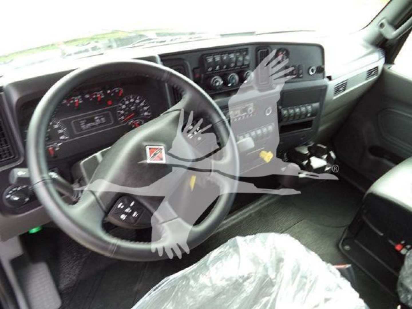 Interior of 2025 International MV truck showing steering wheel, gauge cluster, and center console with controls.