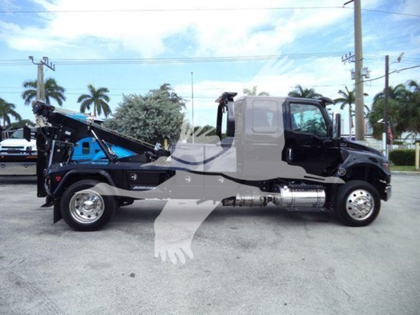 International MV truck with tow winch system, side view showing cab, chassis, and winch apparatus.