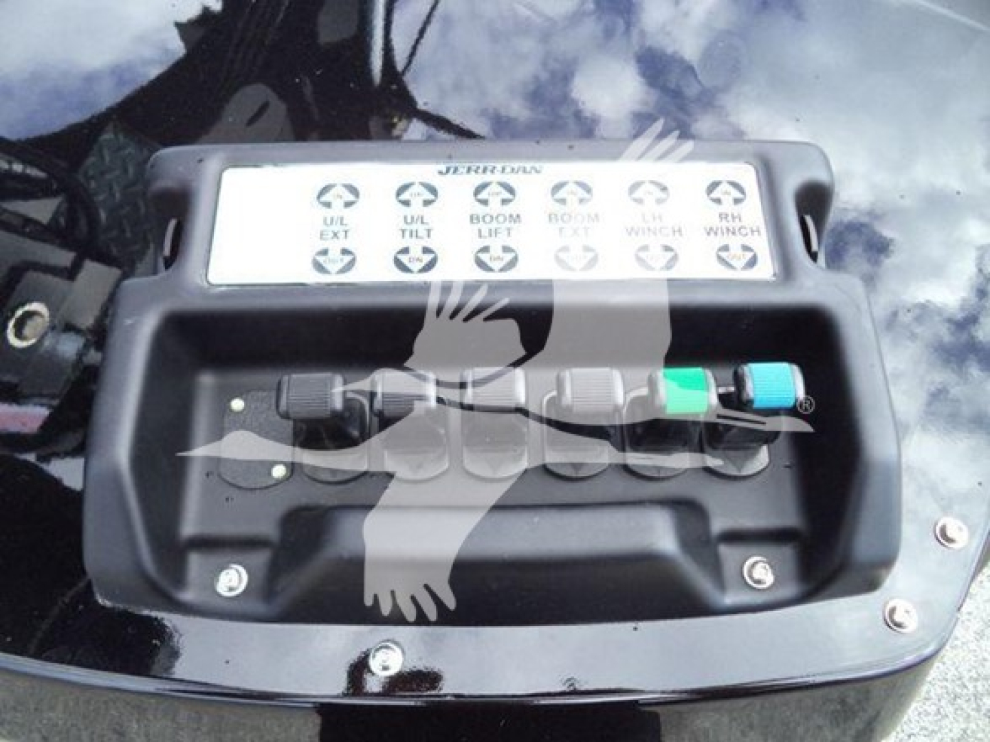 Winch control panel with labeled levers on a truck job site showing multiple indicators and color-coded connectors.