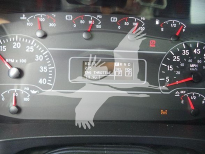 Dashboard of a 2025 International MV showing multiple gauges and a digital display with gear indicator and RPM/engine metrics.
