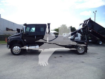 2025 International MV dump truck with a mounted dump bed and winch system. Side view shows cab, dual rear wheels, chrome exhaust, and warning decals.