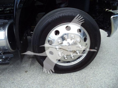 Wheel with chrome hub and Conti tire on a truck, close-up view of front wheel and fender.