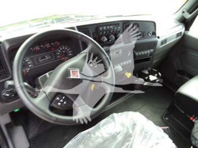 Interior of 2025 International MV truck showing steering wheel, gauge cluster, and center console with controls.