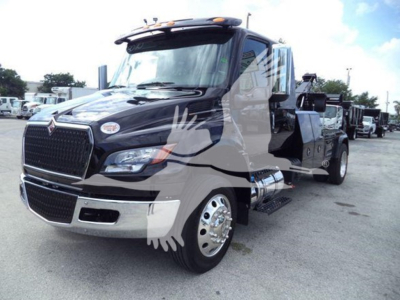 International MV truck cab in service showing front grille, headlights, side mirror, chrome bumper, and side steps with winch category text.