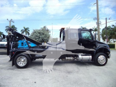 Truck side view showing 2025 International MV with a dump bed and winch equipment.