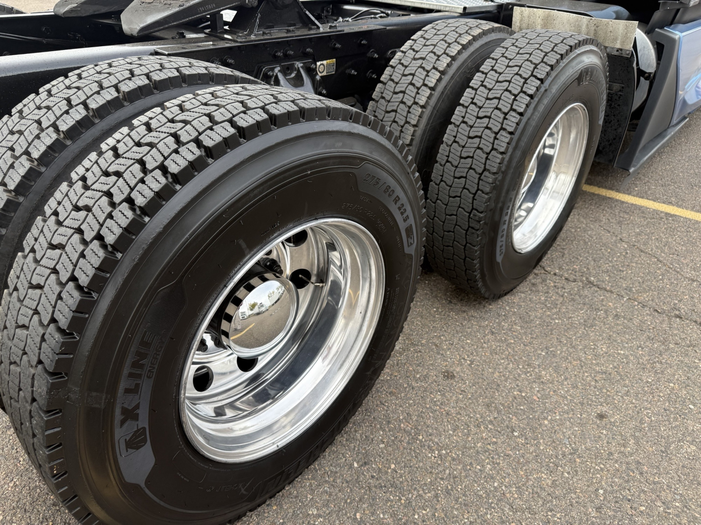 Kenworth T680 rear dual-axle truck wheels with Krex Kenda tires and shiny polished rims; part of a sleeper cab tractor in view.